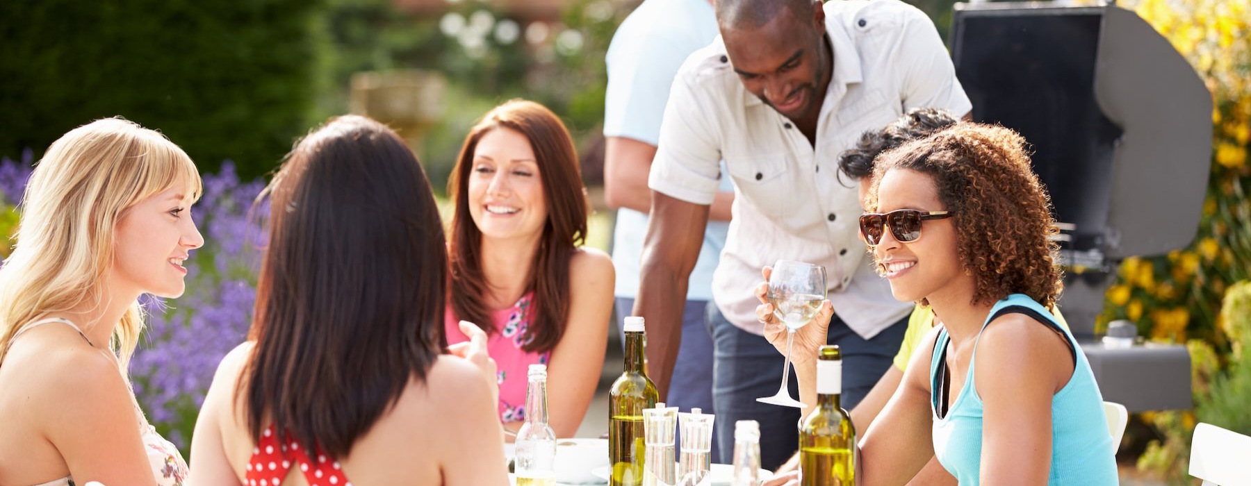 people sitting at a table with drinks and food
