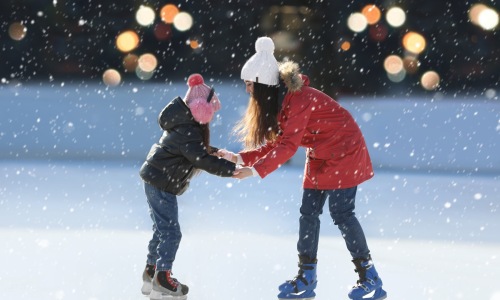 a mother and daughter ice skating